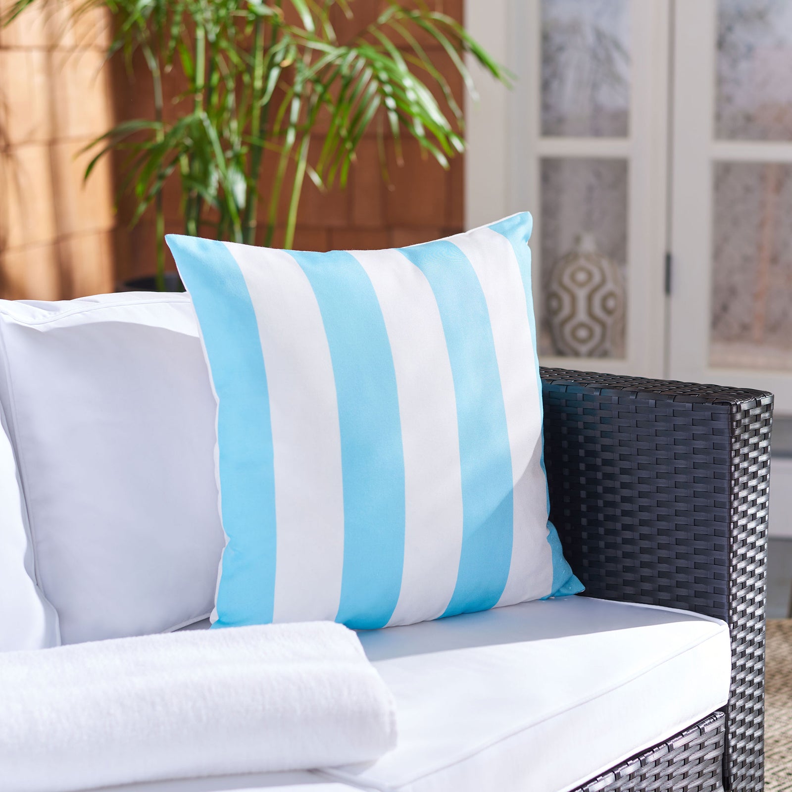 Light blue and white stripes add a fresh pop of color to wicker seating || PPL263C-1818 || front_room