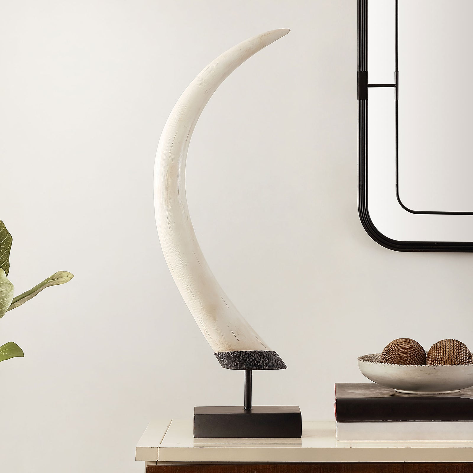 A tall, curved white sculpture on a slim black stem and rectangular base adds an artful touch to a console. || RDC1203A || front_room