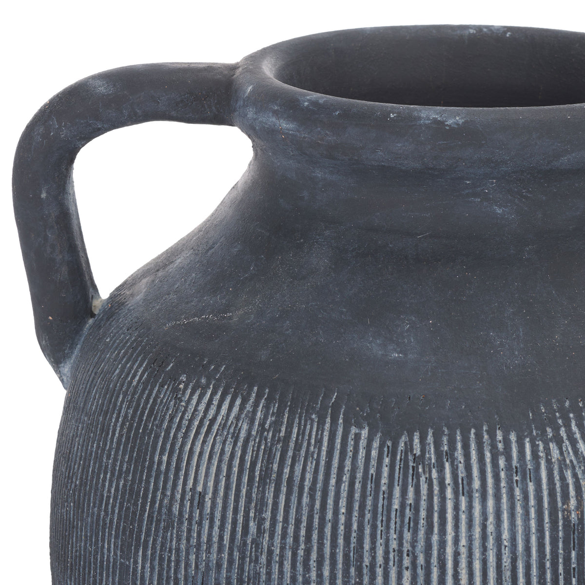 A rolled rim and loop handle frame fine, white-highlighted ribbing on charcoal-black stoneware