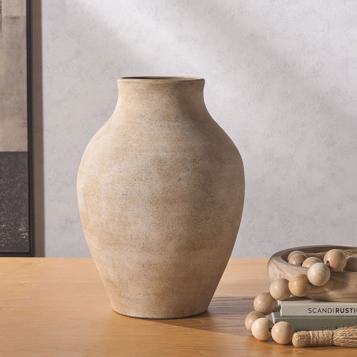 A rounded, weathered stoneware vase adds understated texture and warm natural tones to a tabletop. || RDC1211A || front_room