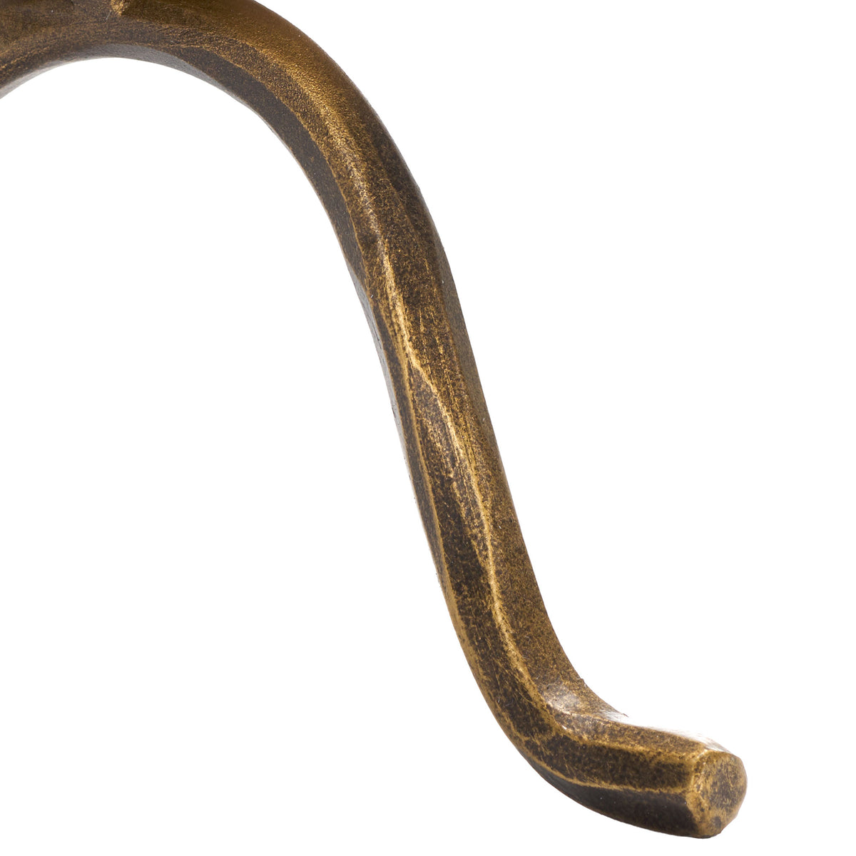 A gently curved iron foot ends in a rounded tip, revealing a textured, antique brass-toned finish