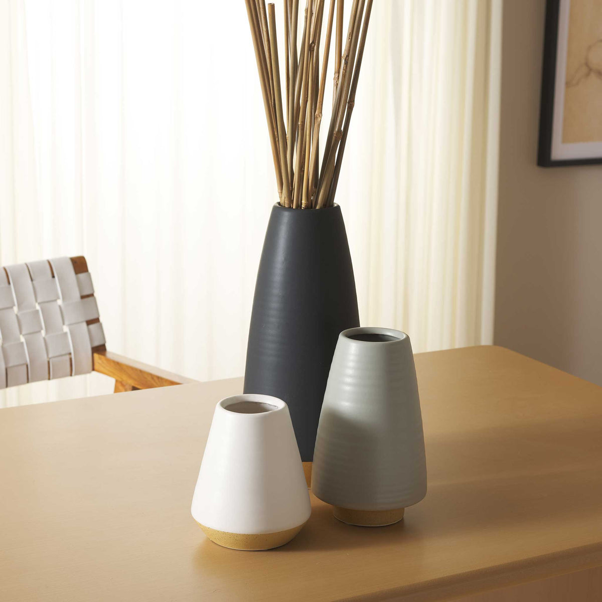 Sleek ceramic vases elevate any tabletop with neutral glazes and a grounded natural base || RDC4009A-SET3 || front_room