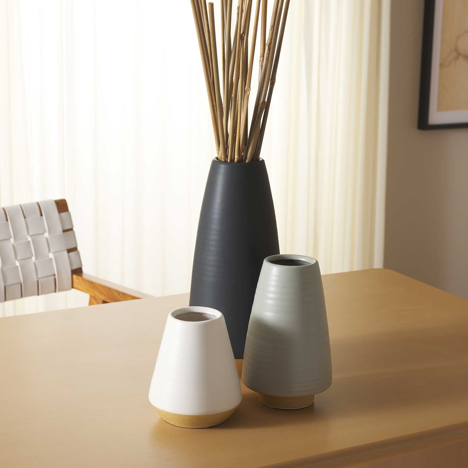 Sleek ceramic vases elevate any tabletop with neutral glazes and a grounded natural base || RDC4009A-SET3 || front_room