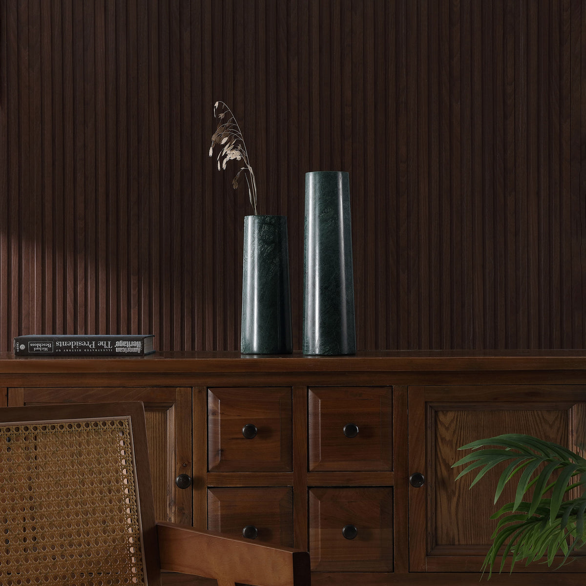 Green marble vases accent a warm wood cabinet, with a dried stem in the shorter vase. || RDC4025A-SET2 || front_room
