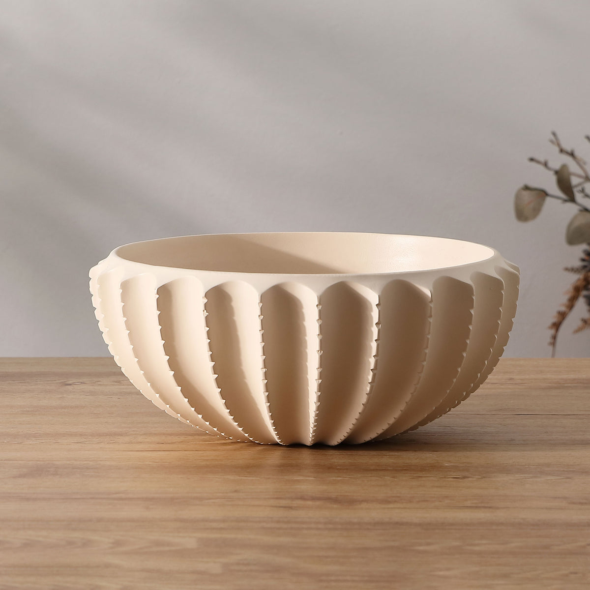 Cream bowl adds soft color and sculptural scalloped texture to a tabletop