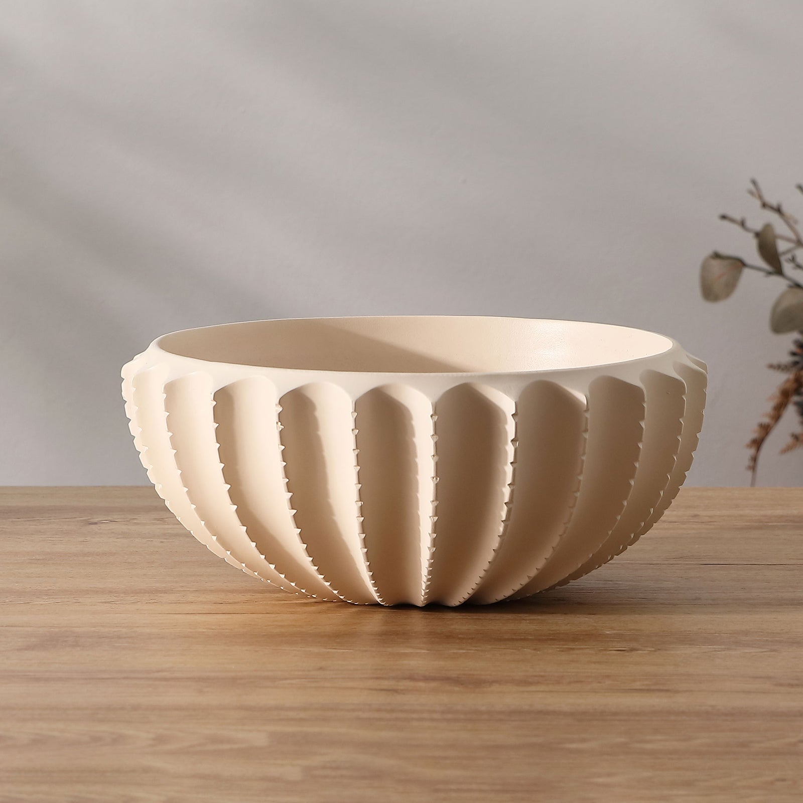 Cream bowl adds soft color and sculptural scalloped texture to a tabletop || RDC4033A || front_angle_room