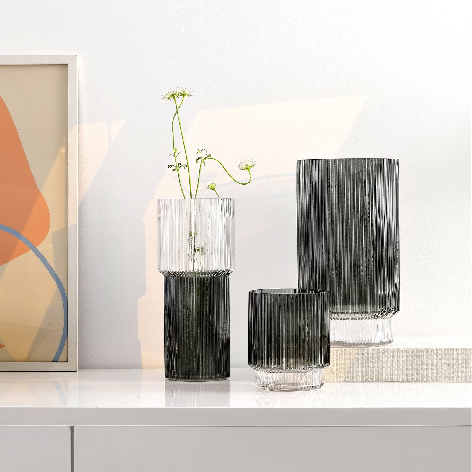 Three blue-gray glass vases bring varied heights and sculptural ribbing to a console display. || RDC4034A-SET3 || front_angle_room