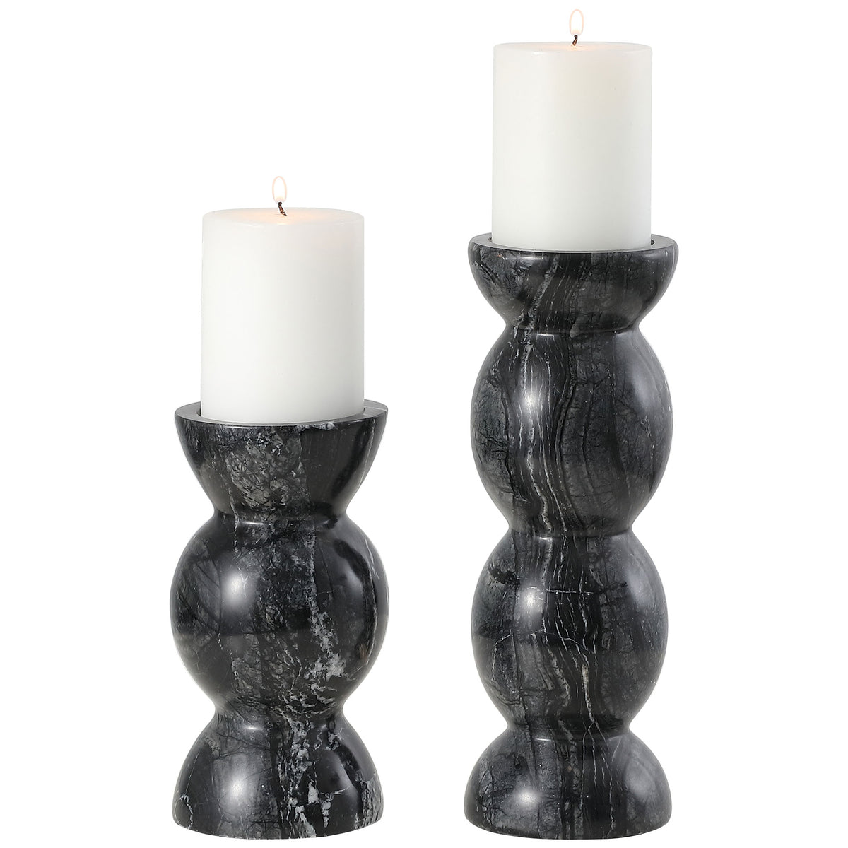 White pillar candles rest in two sculptural gray marble holders with softly rounded forms. || RDC4037A-SET2 || front_studio