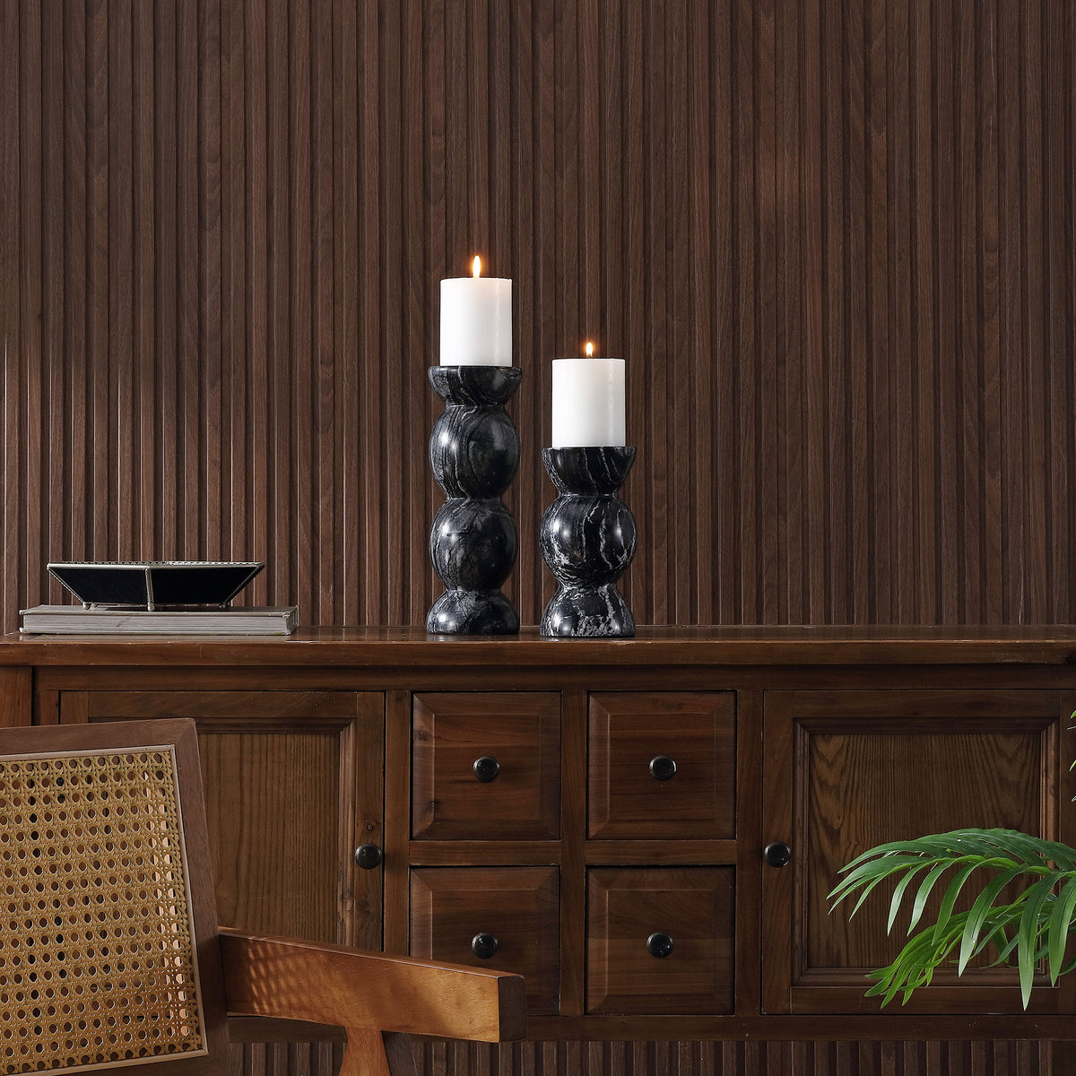 Two sculpted marble candle holders bring rich gray veining and a warm candlelit glow to a wood sideboard. || RDC4037A-SET2 || front_room