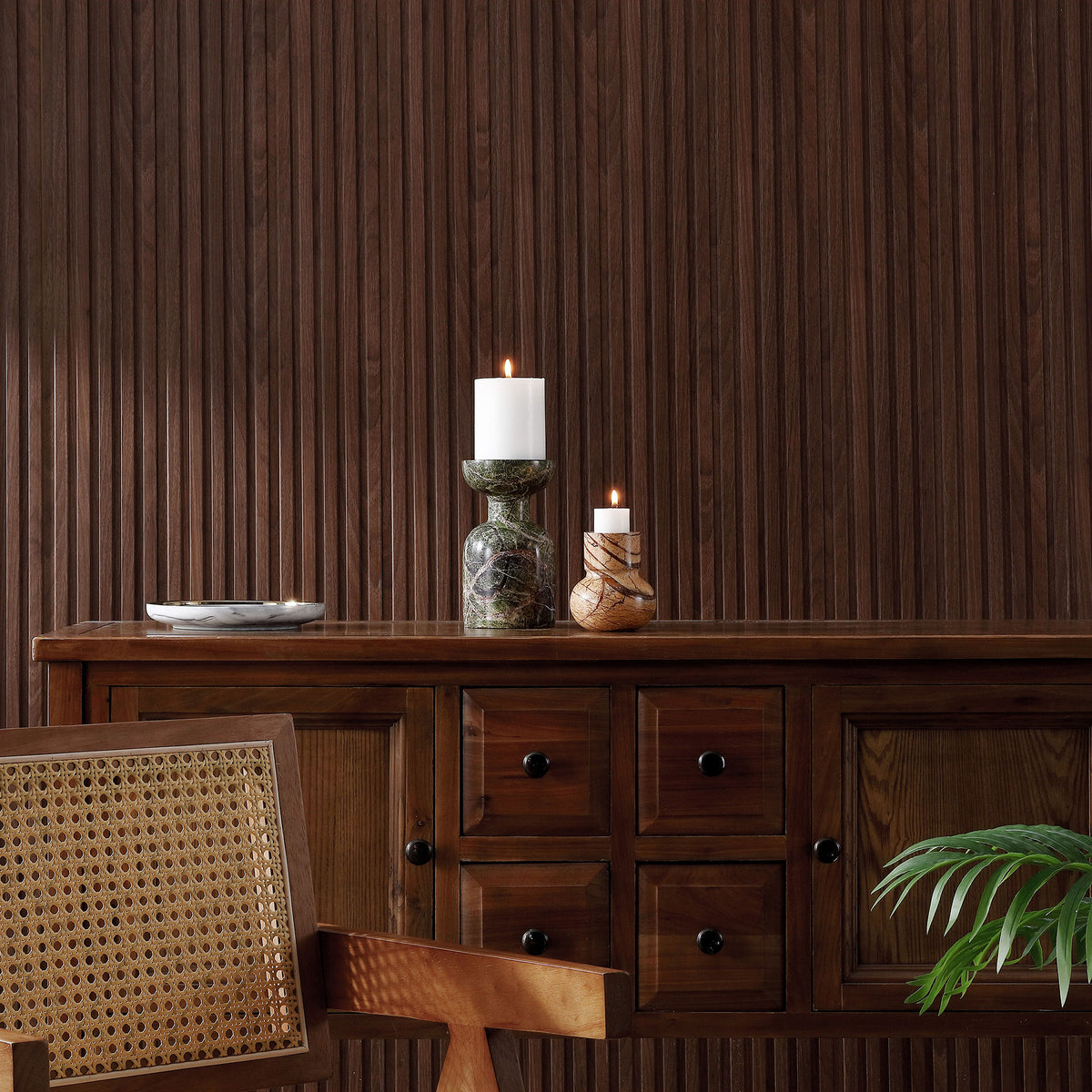 Glowing white candles atop green and tan marble holders add warmth to a wood-paneled space. || RDC4038A-SET2 || front_room