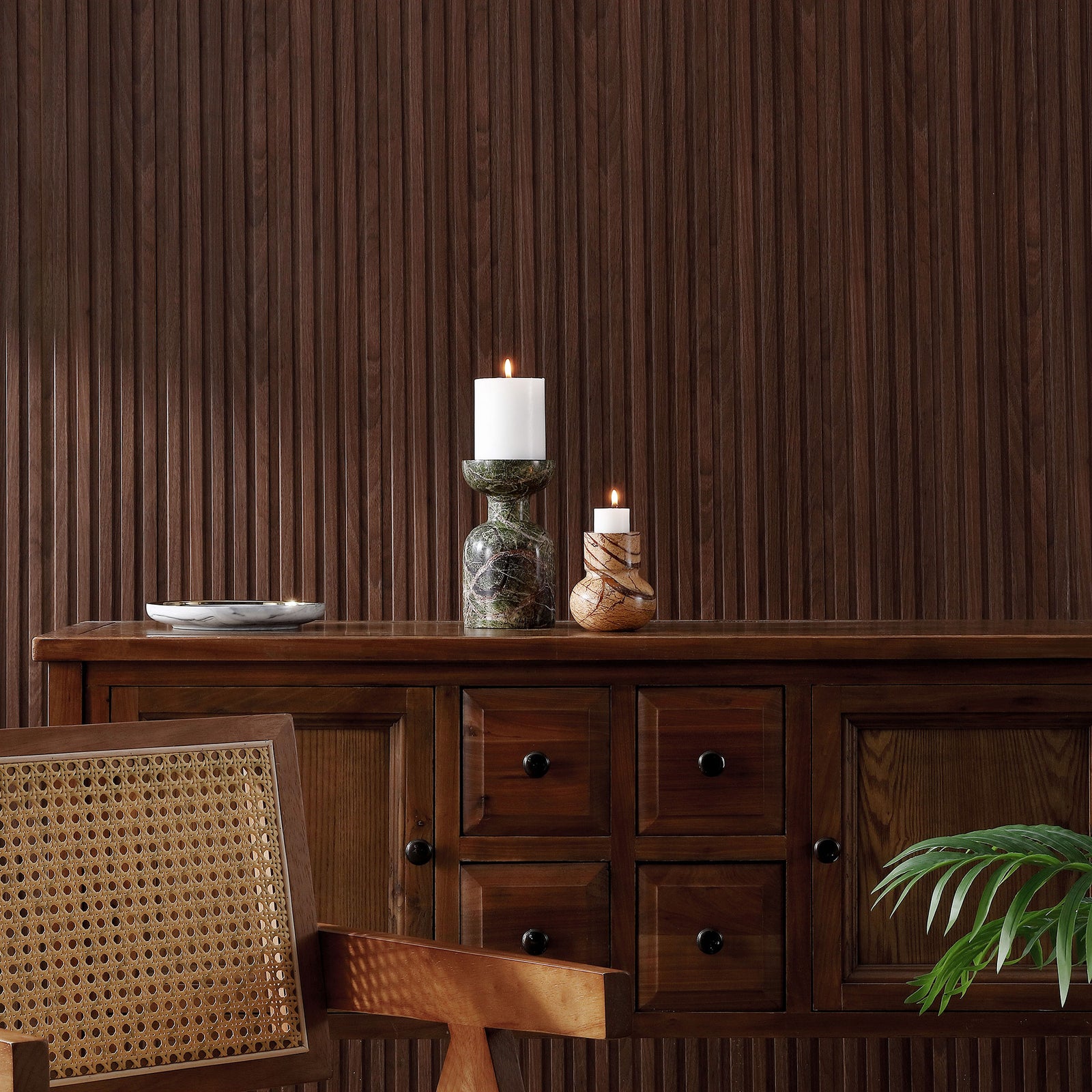 Glowing white candles atop green and tan marble holders add warmth to a wood-paneled space. || RDC4038A-SET2 || front_room