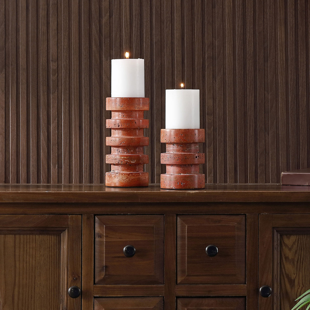 Graduated stacked-ring holders pair warm, pitted stone with glowing white pillar candles. || RDC4043A-SET2 || front_room