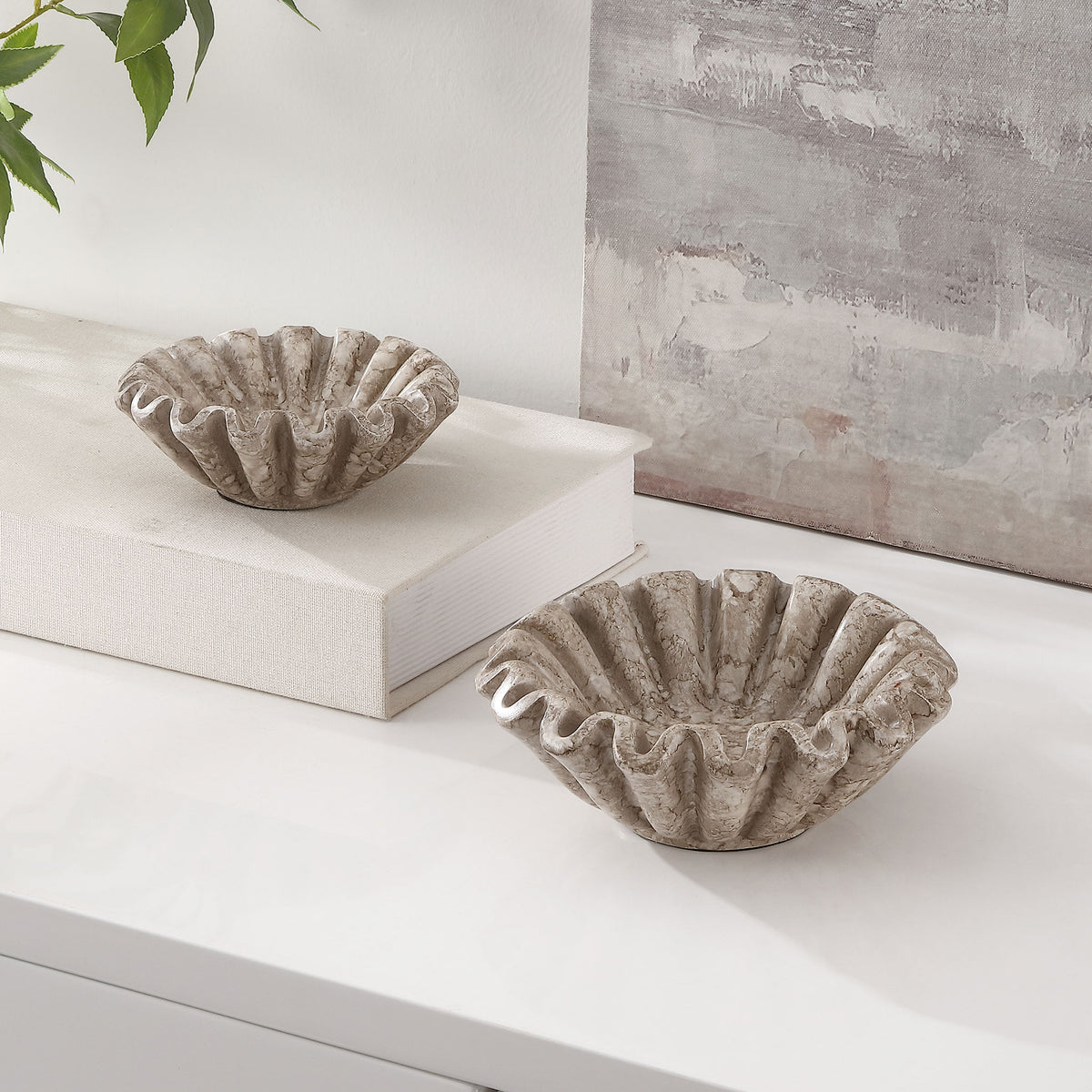 Two ruffled bowls add organic curves and a weathered stone-like finish to a bright interior.