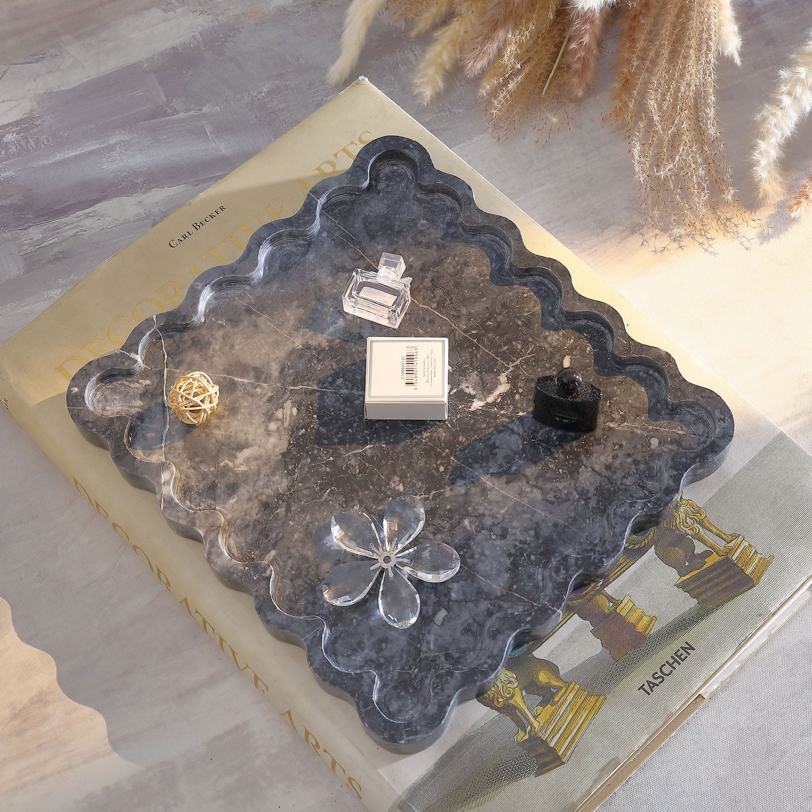 Scalloped charcoal marble tray holds decorative accents atop its veined surface. || RDC4054A || top_angle_room