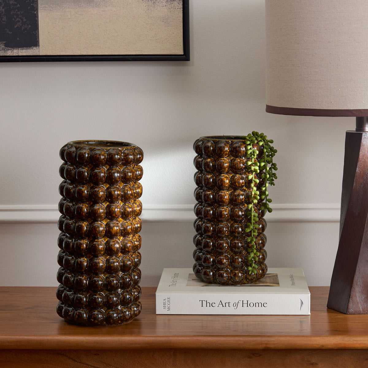 Glossy brown beaded vases add warmth to a wood console, with greenery trailing from one vessel. || RDC4061A-SET2 || front_room