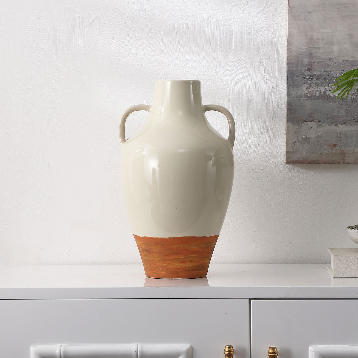 Twin loop handles and an earthy brown base make the glossy ivory vase a warm decorative accent. || RDC4062A || front_room