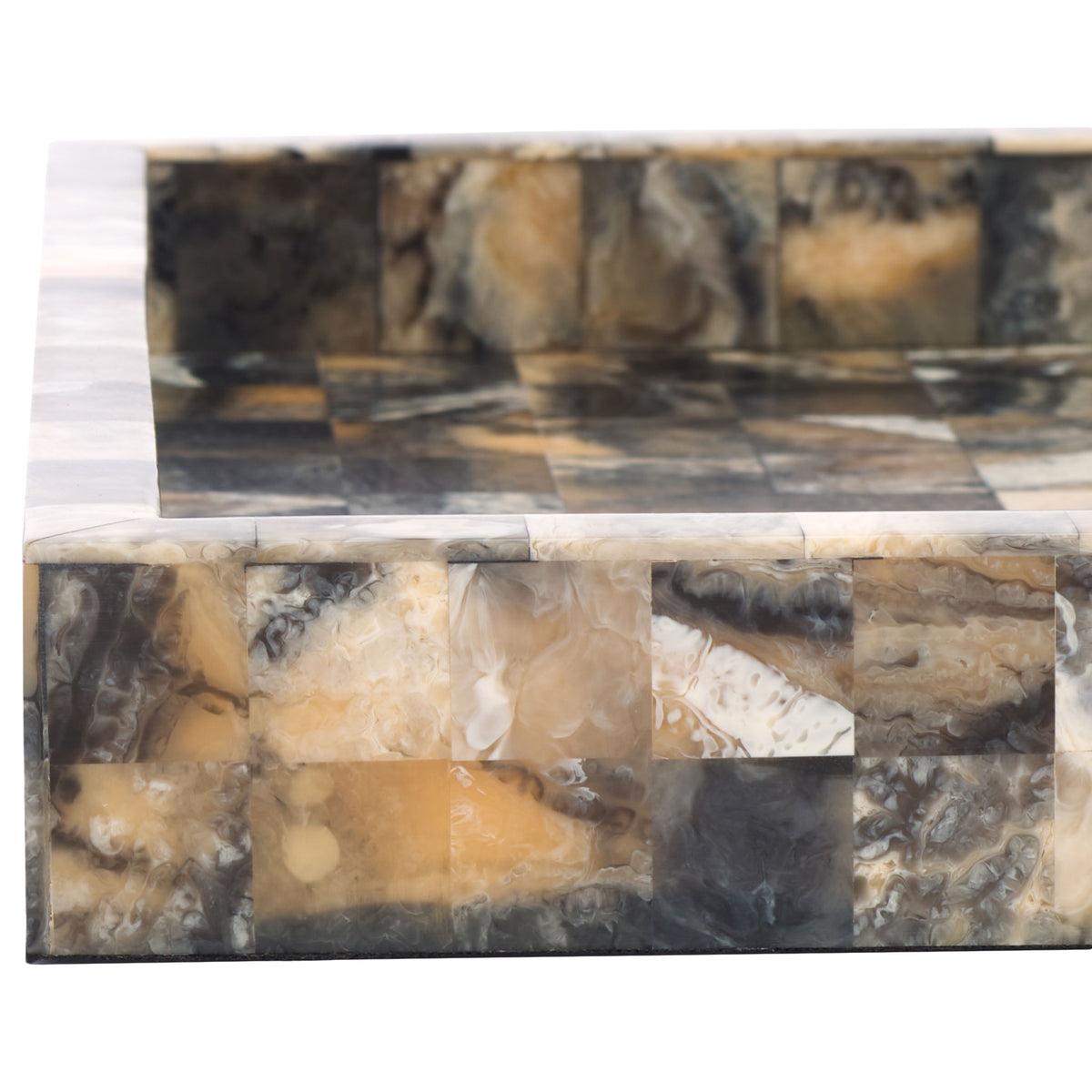 Shallow raised rims frame marbled squares in smoky charcoal, honey, and creamy ivory.