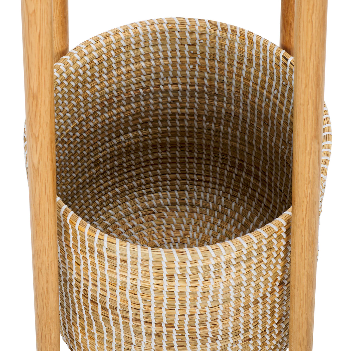 A woven basket with white accents offers storage between natural wood supports.