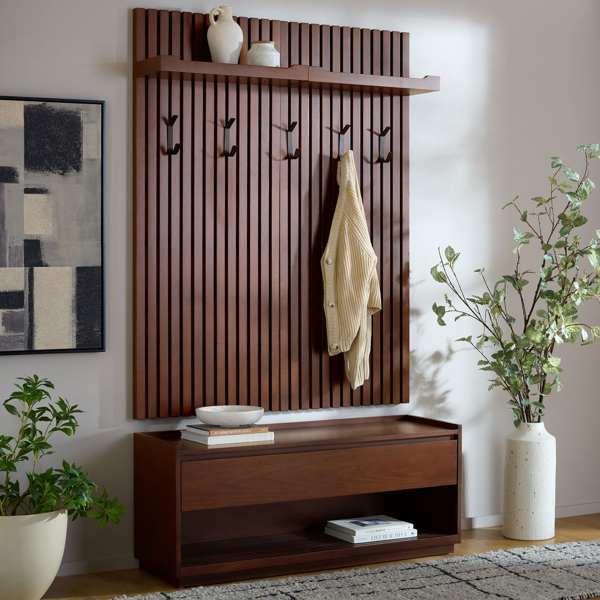Warm wood slats and black hooks bring inviting style to an entryway bench with open lower storage