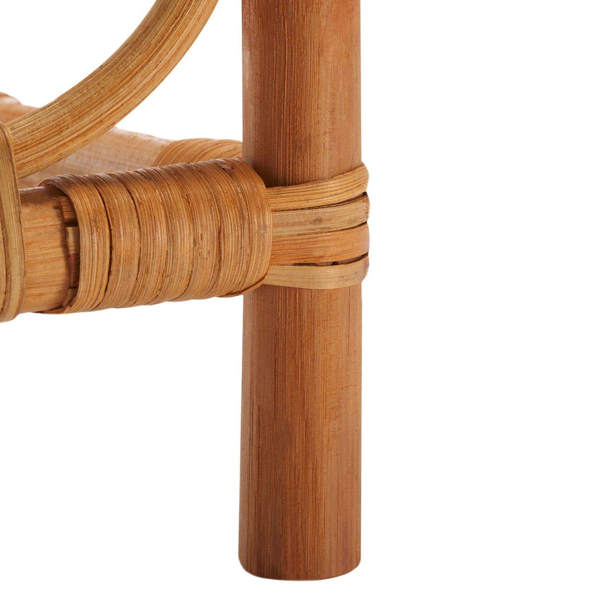 Rounded rattan feet and wrapped support joints add a handcrafted touch to the open rack