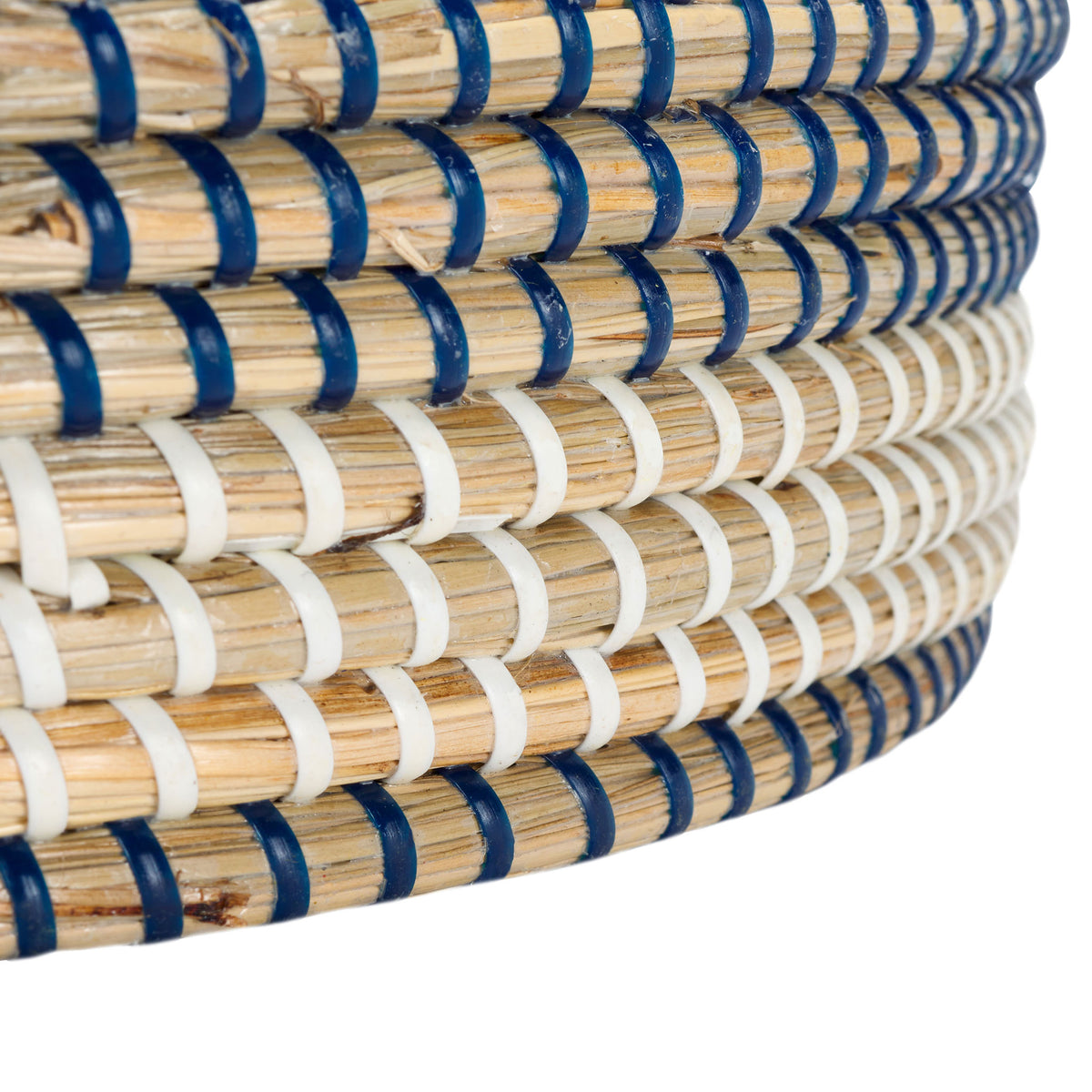 A deep blue border finishes the lower edge beneath layers of white-wrapped seagrass coils.