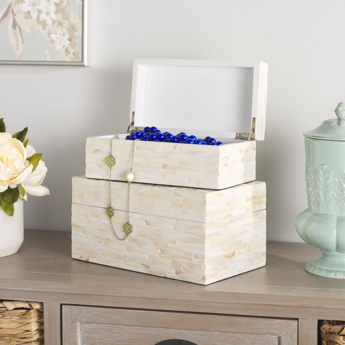 A smaller hinged box holds colorful beads and jewelry atop its larger pearly companion.