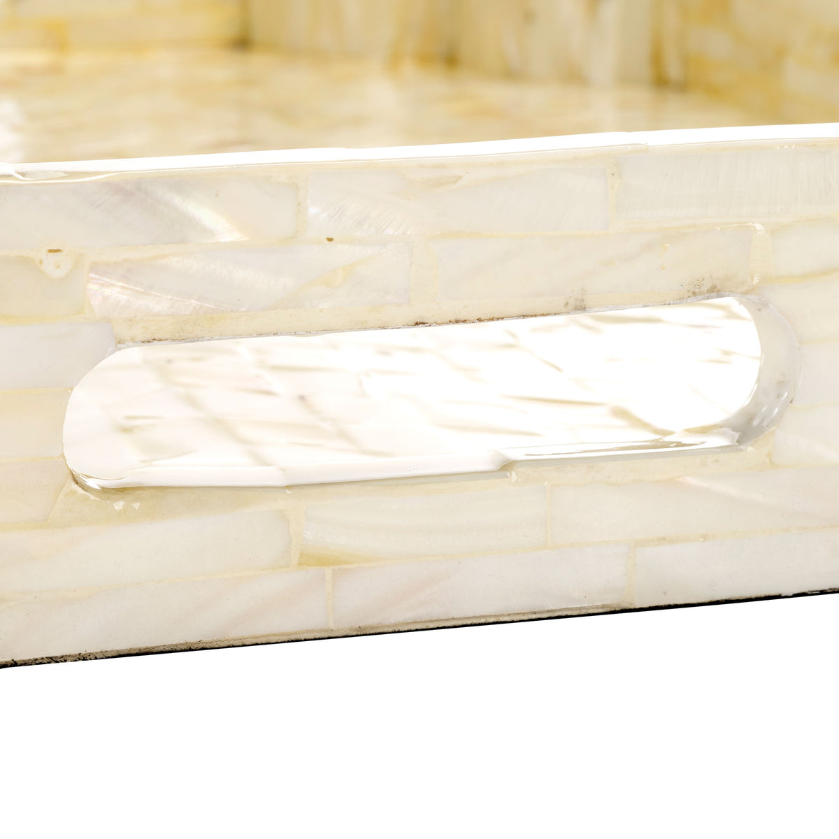 An integrated cutout handle makes this luminous mother-of-pearl tray easy to carry