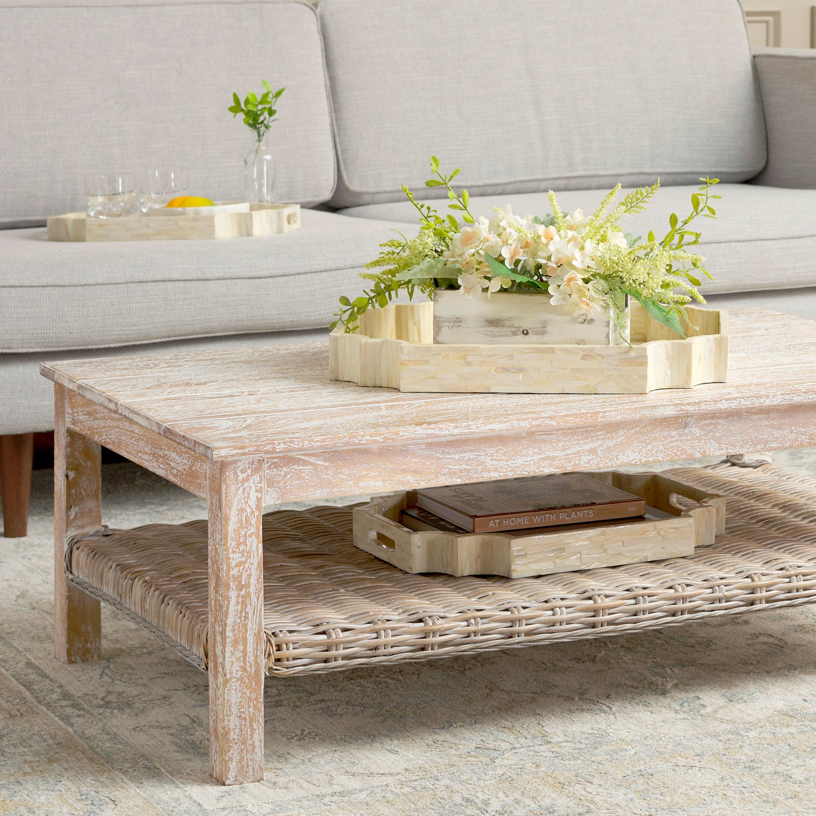 Graduated champagne trays display flowers, drinks, and books throughout a relaxed living room || STG1811A || front_angle_room