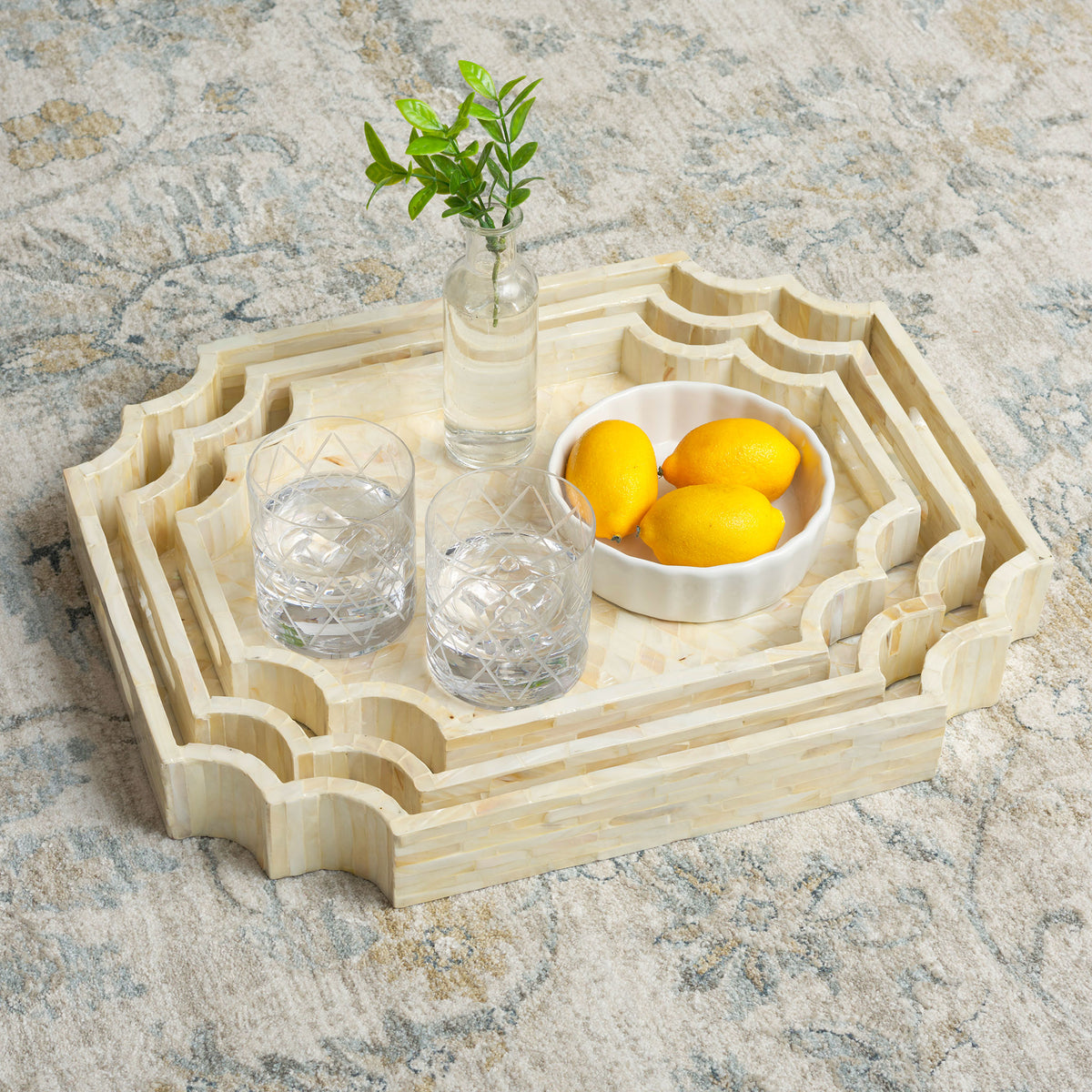 Nested trays bring pearly warmth to a spread of drinks, lemons, and greenery || STG1811A || front_angle_room