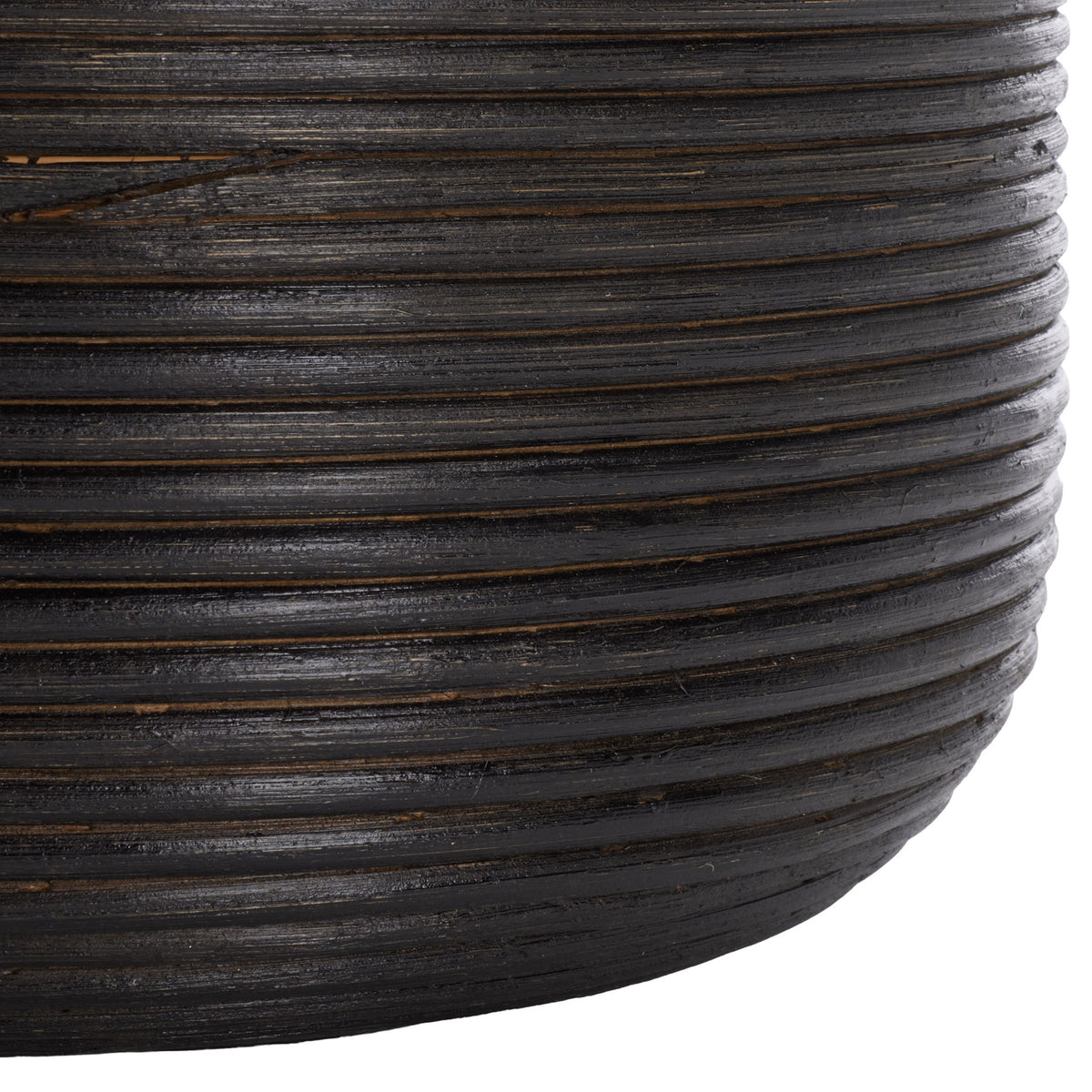 Dark coiled rattan curves around the basket's base for rich texture and a smooth rounded shape