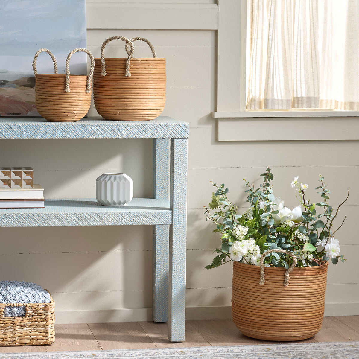 Natural rattan baskets bring warm storage to a console and hold flowers beside it. || STG1817A || front_room