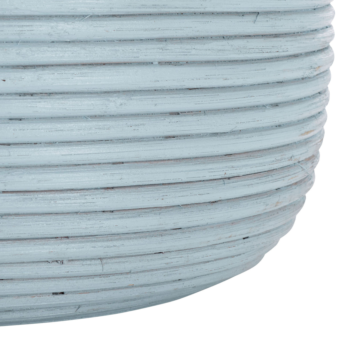 The rounded basket base shows light blue rattan coils and subtle variations in its painted finish.