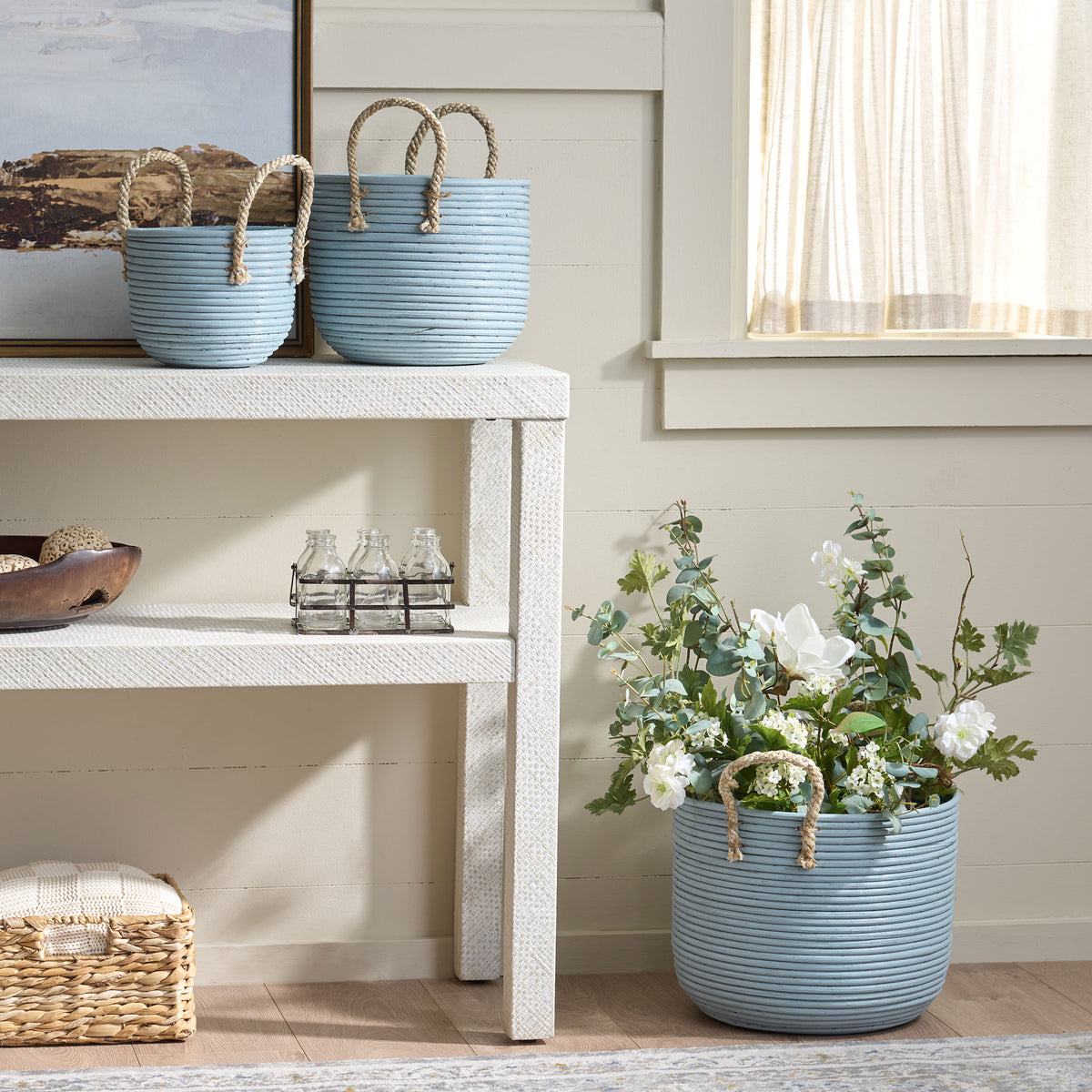 Light blue baskets add storage to a shelf while the largest holds a lush floral arrangement. || STG1817B || front_room