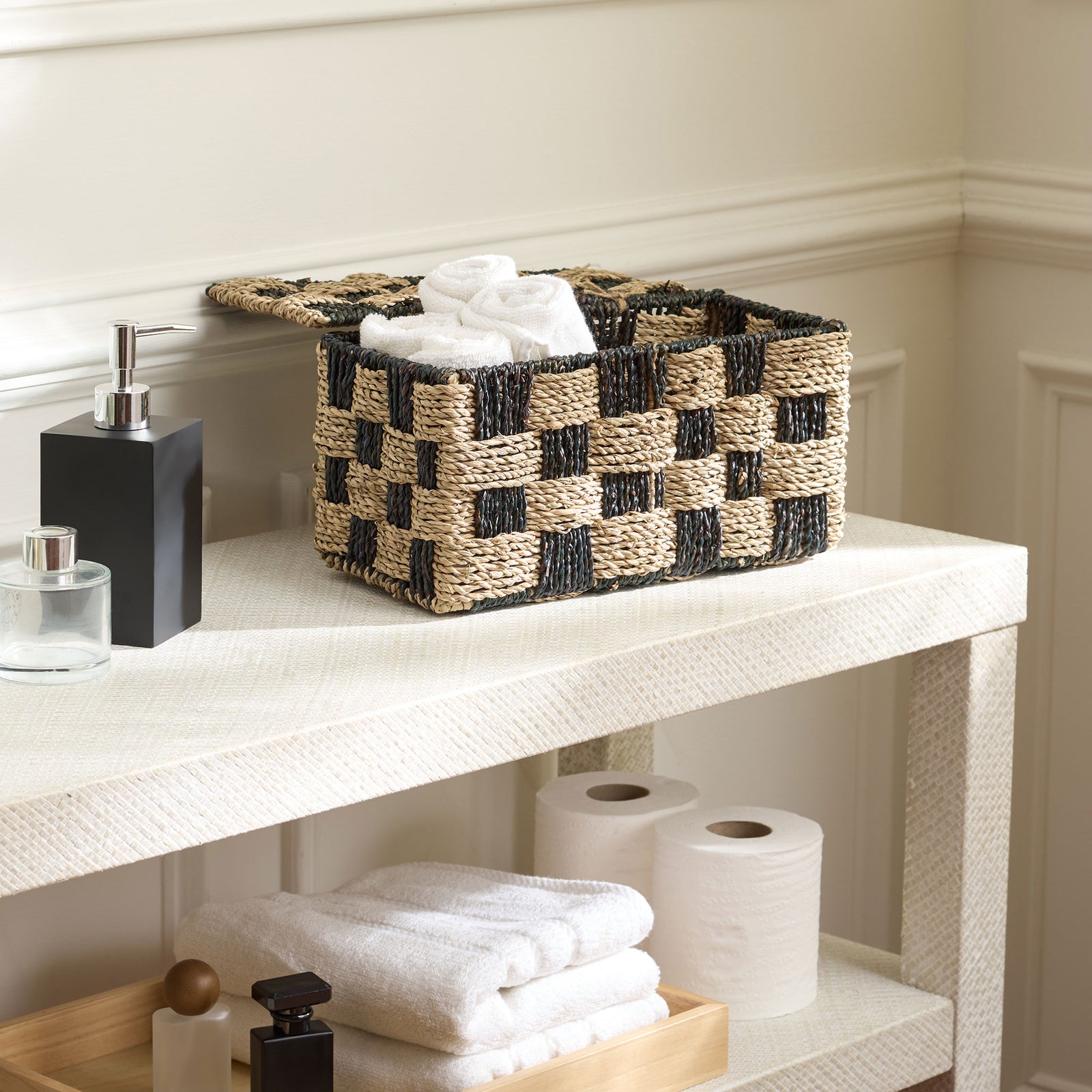 This open seagrass basket keeps fresh towels within reach behind its striking two-tone weave. || STG1822A || front_angle_open_room