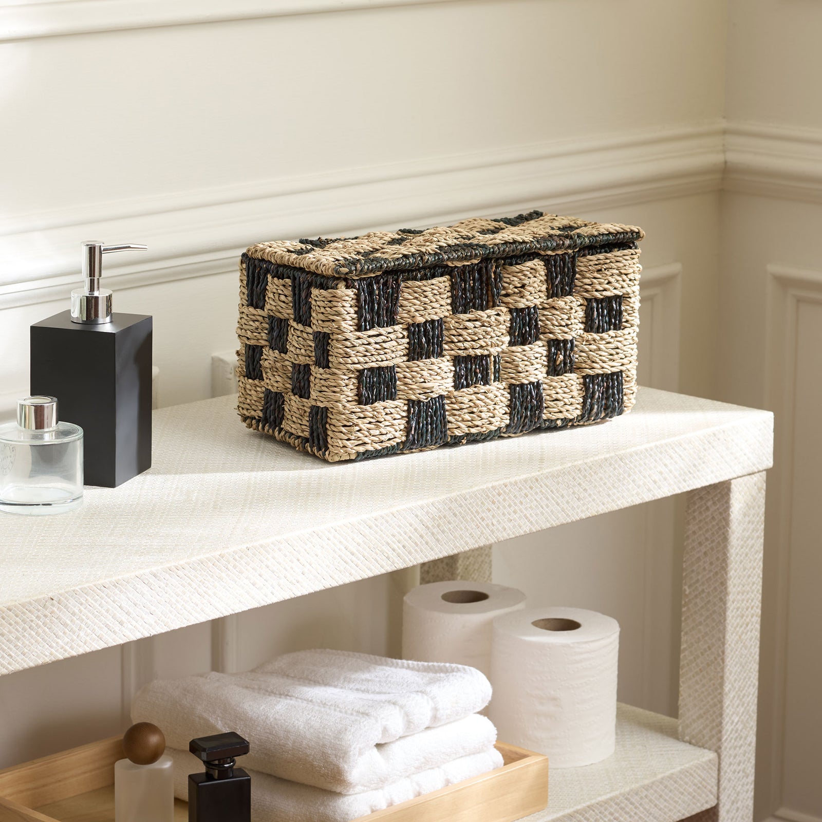 A lidded basket lends natural texture and graphic contrast to bathroom storage. || STG1822A || front_angle_room