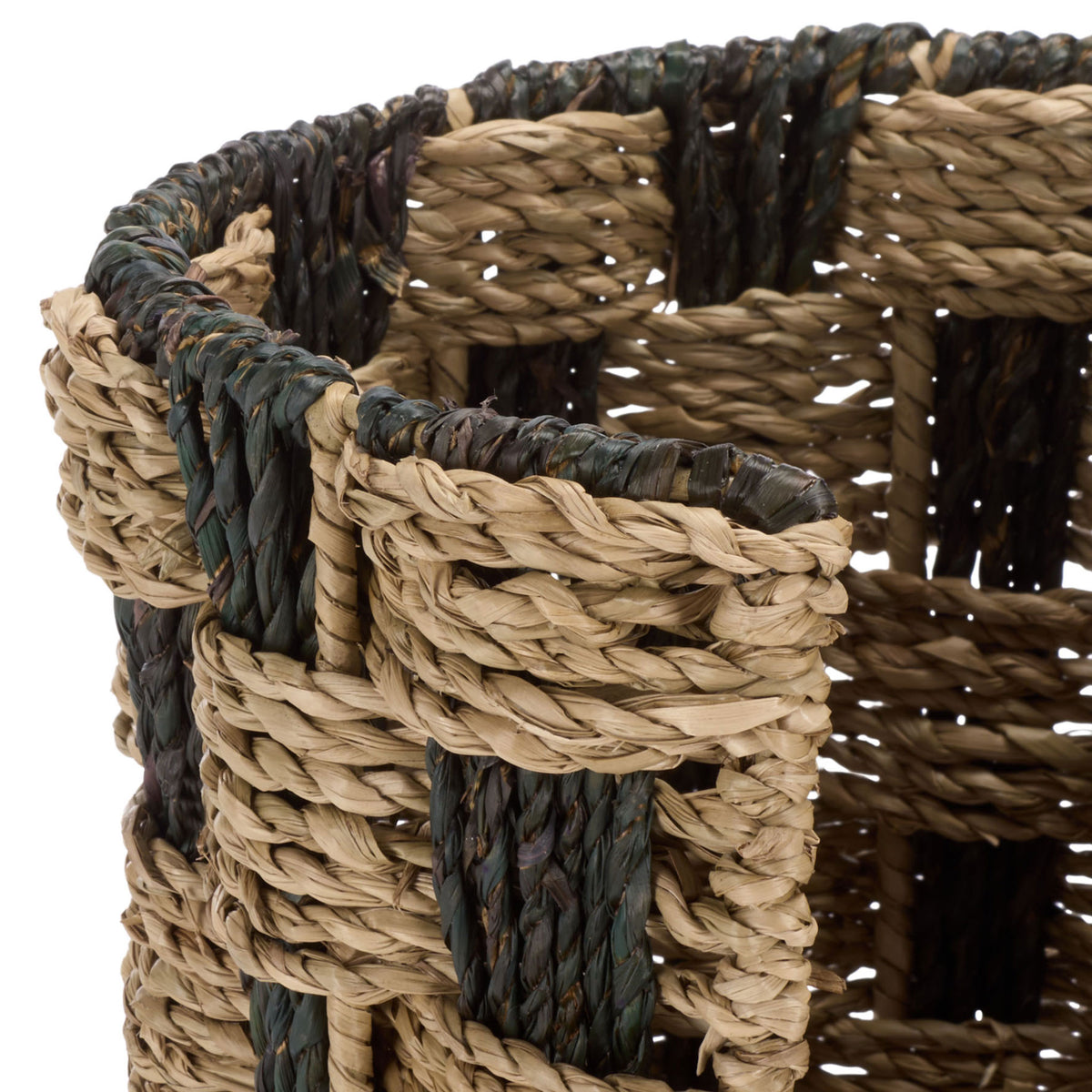 Thick braided seagrass frames the basket's opening in natural and dark tones.
