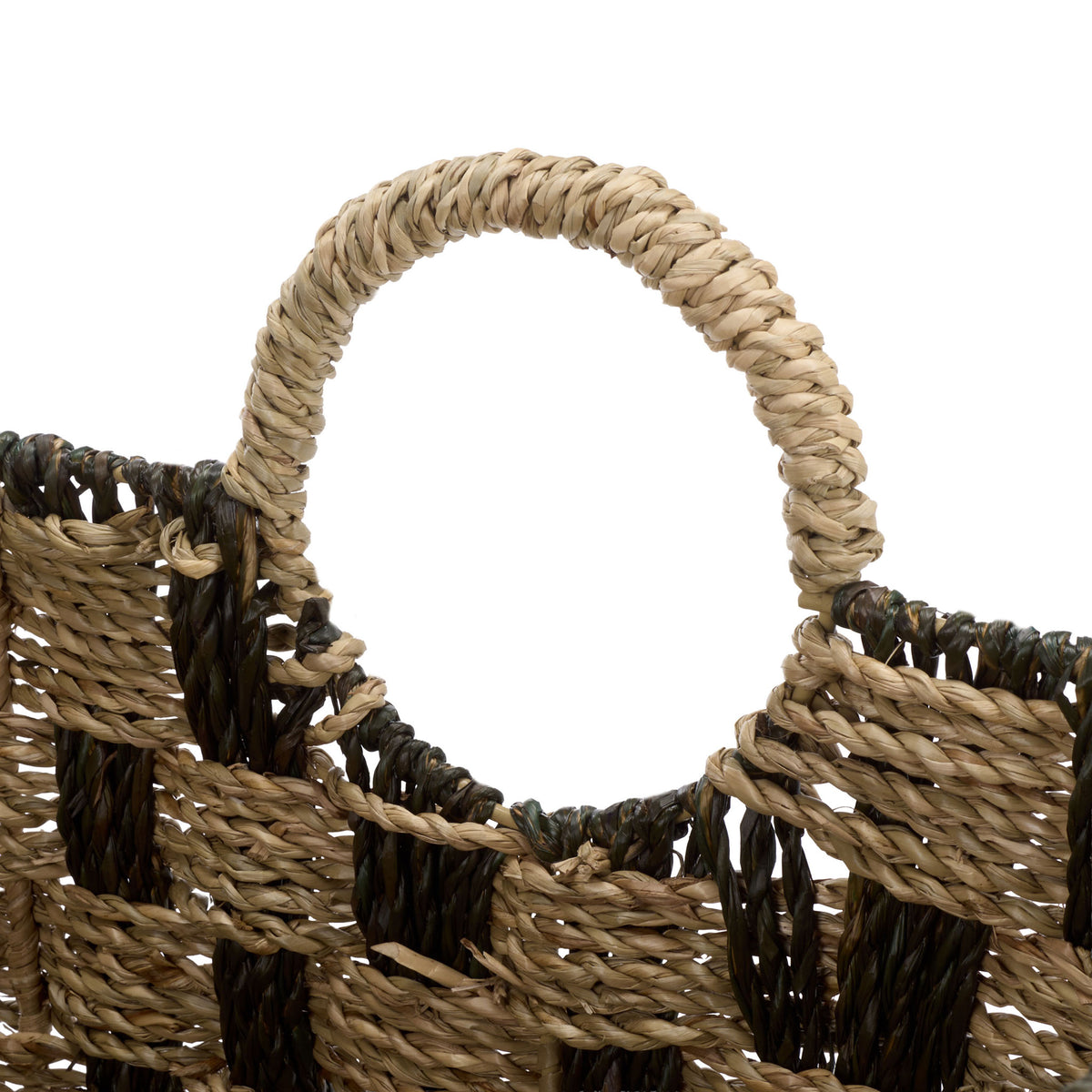 A seagrass-wrapped loop handle rises above the open rim and contrasting woven accents.