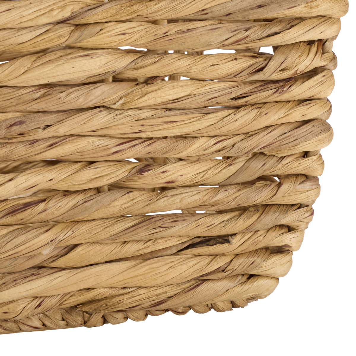 Thick water hyacinth strands meet a tightly bound bottom edge at the basket corner.