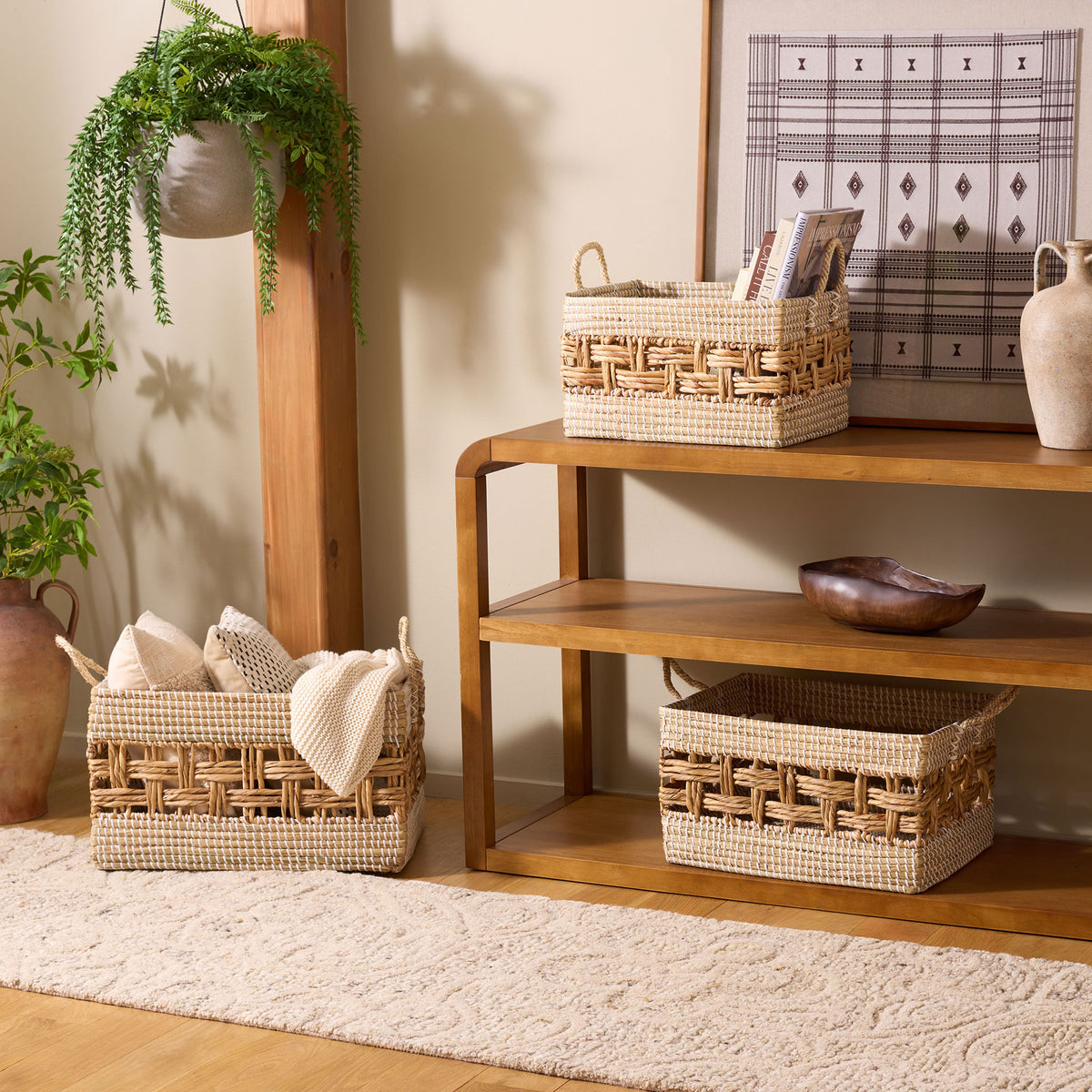 Three natural woven baskets with openwork bands organize books and textiles while adding warm texture || STG1834A-SET3 || front_angle_room