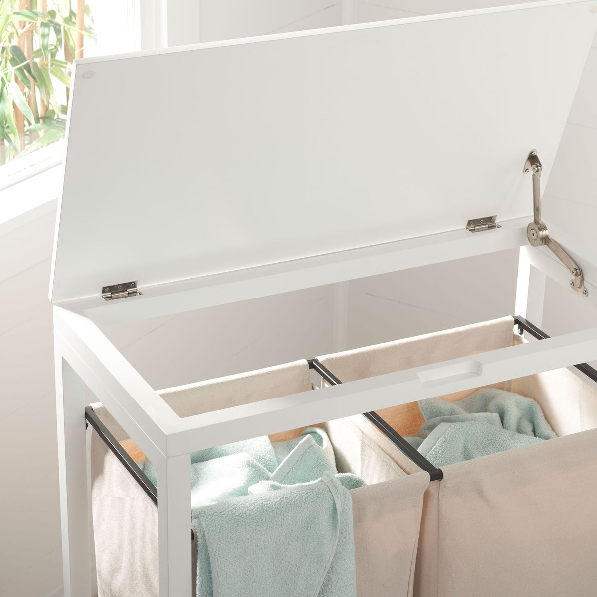 A lifted white lid reveals two separate fabric compartments for sorting towels and laundry. || STG1900A || storage_open_room