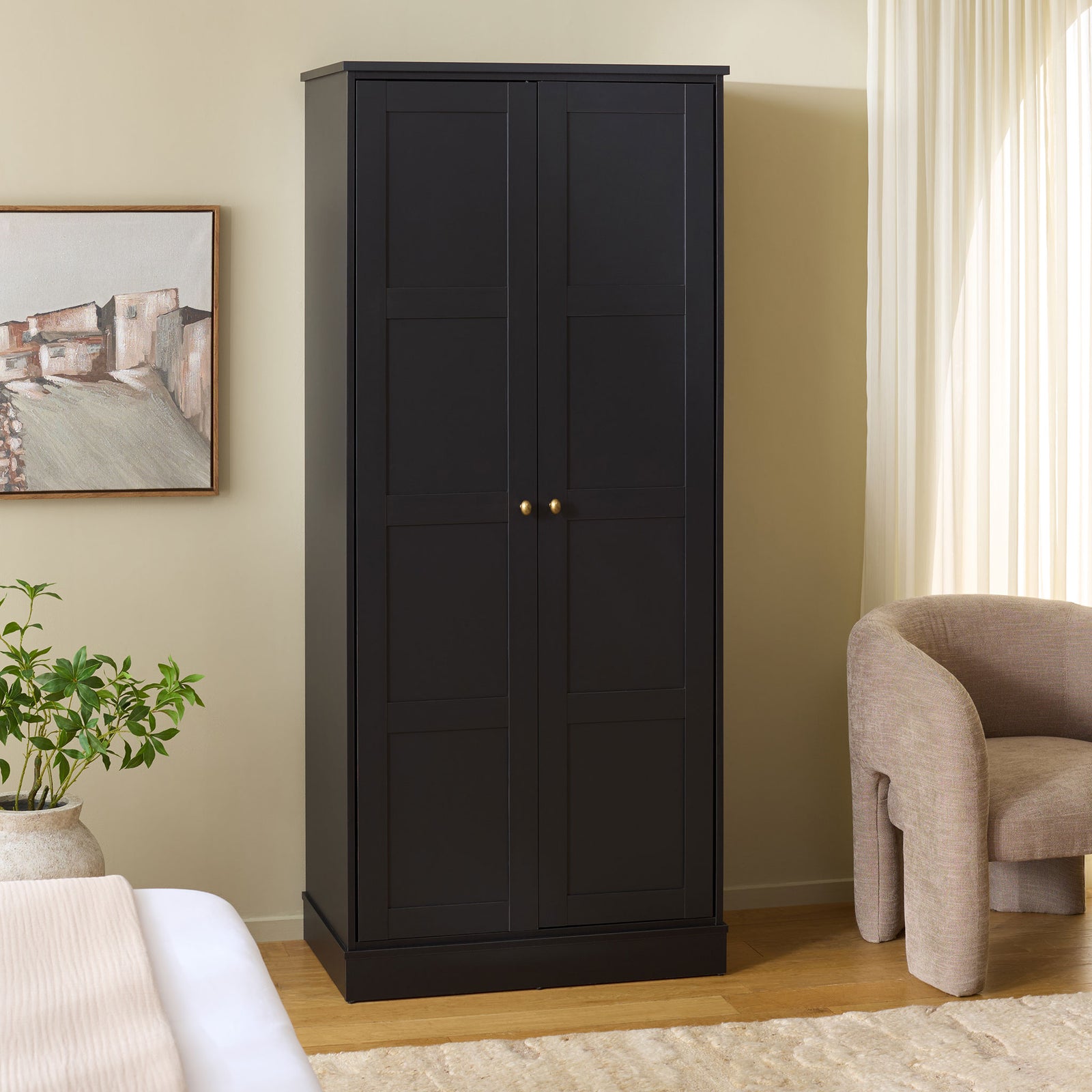 Black paneled wardrobe brings neatly enclosed storage and brass-tone accents to the bedroom. || STG3102C-2BX || front_angle_room