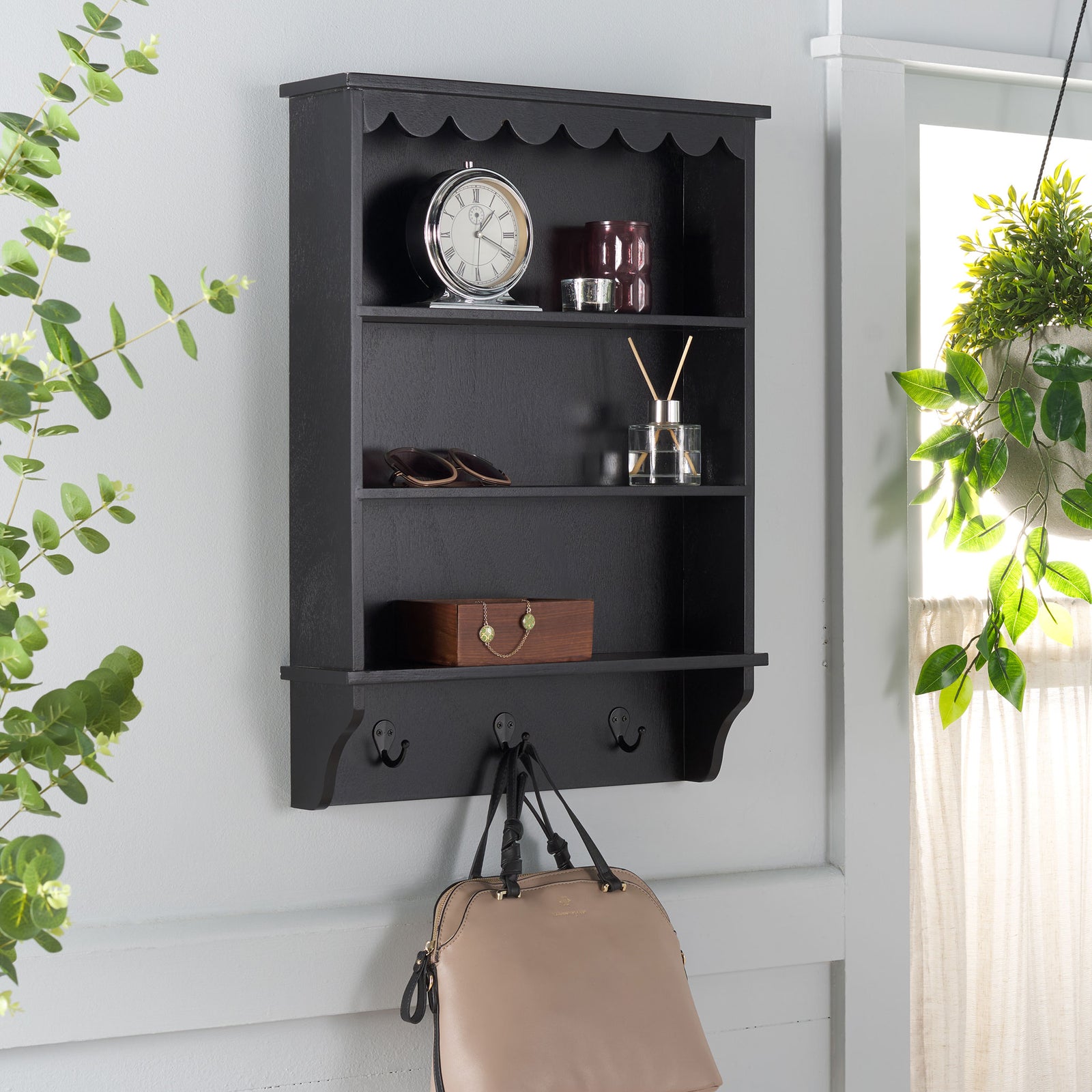 Black wall rack displays small decor and hangs a handbag from a sturdy hook || STG5702B || front_angle_room