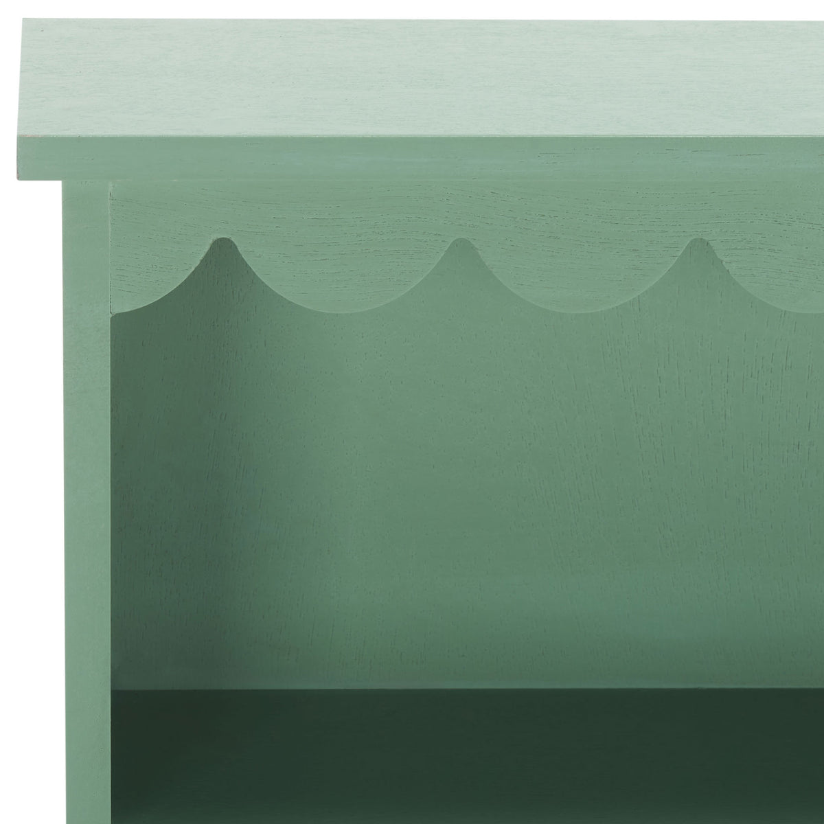 Scalloped top trim adds a playful edge to the sage green wood wall rack