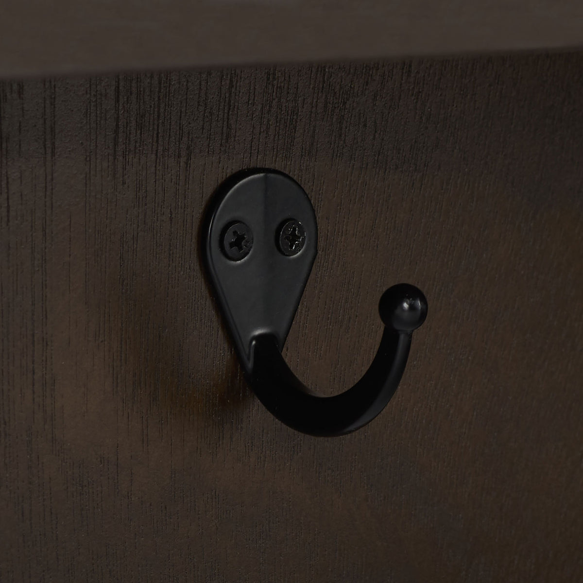 A rounded black metal hook is secured to the dark brown wood with two screws || STG5702F || detail_studio