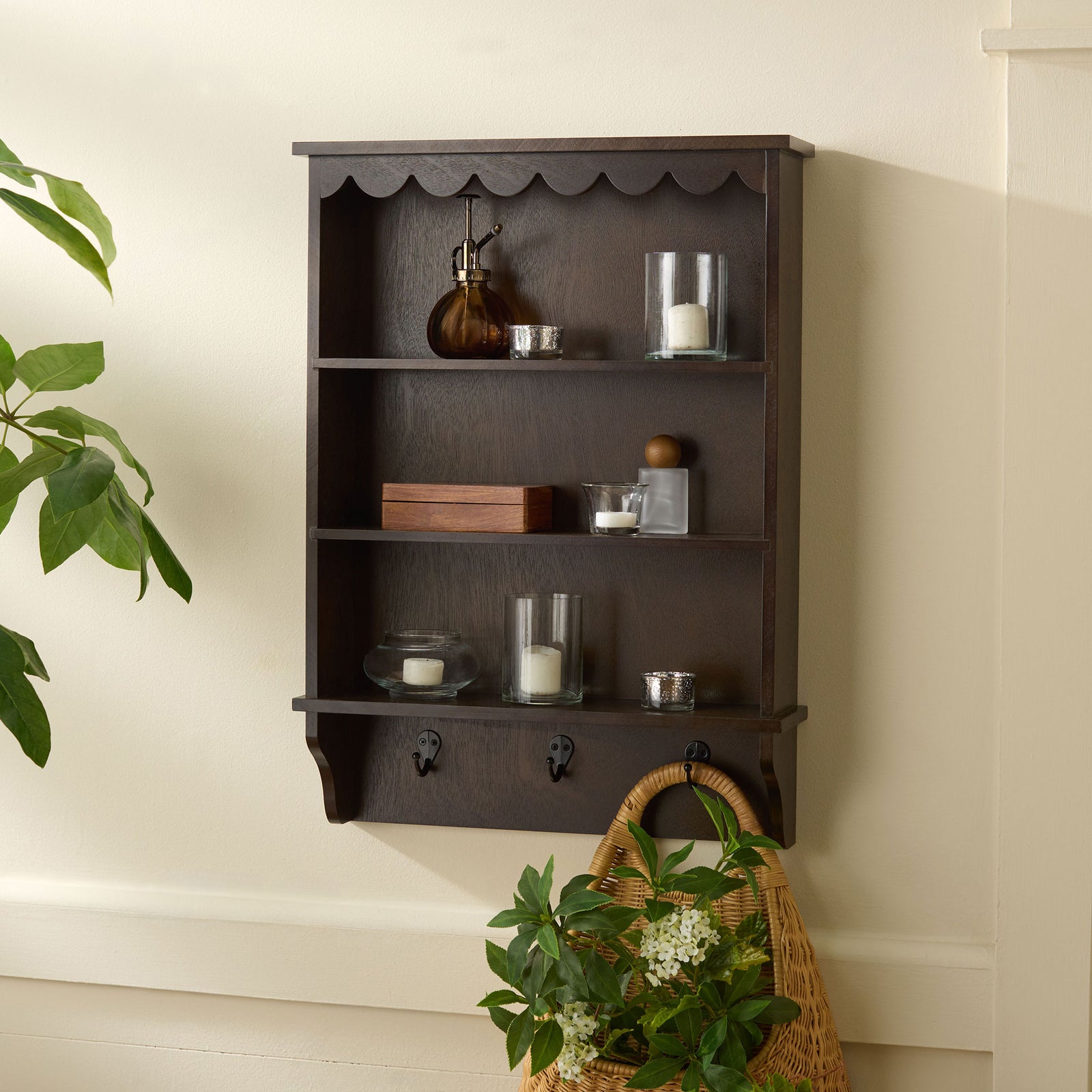 Deep brown shelves keep small accents organized above hooks for hanging a woven basket || STG5702F || front_room