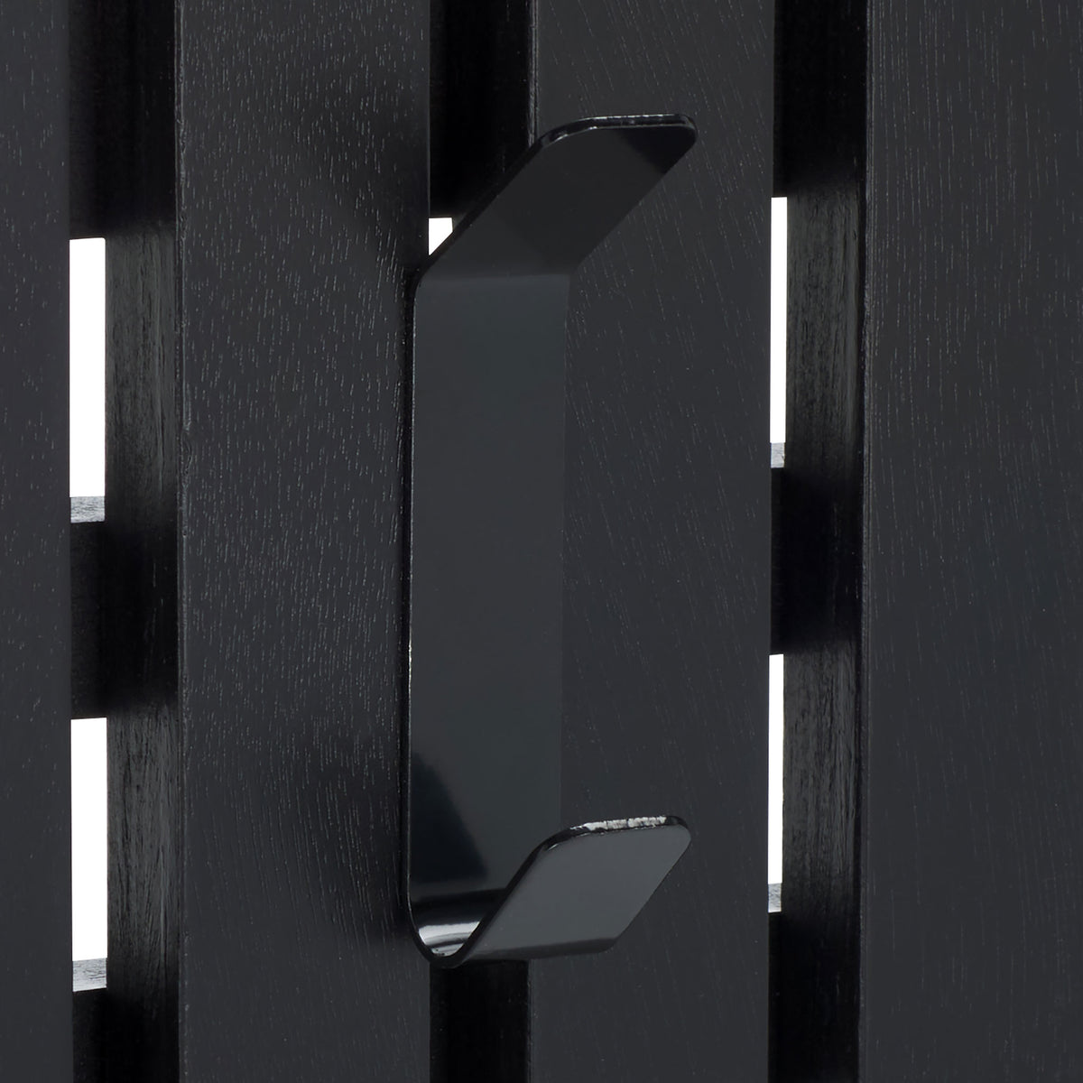 A curved black double hook adds two useful hanging points against sleek black wood slats.