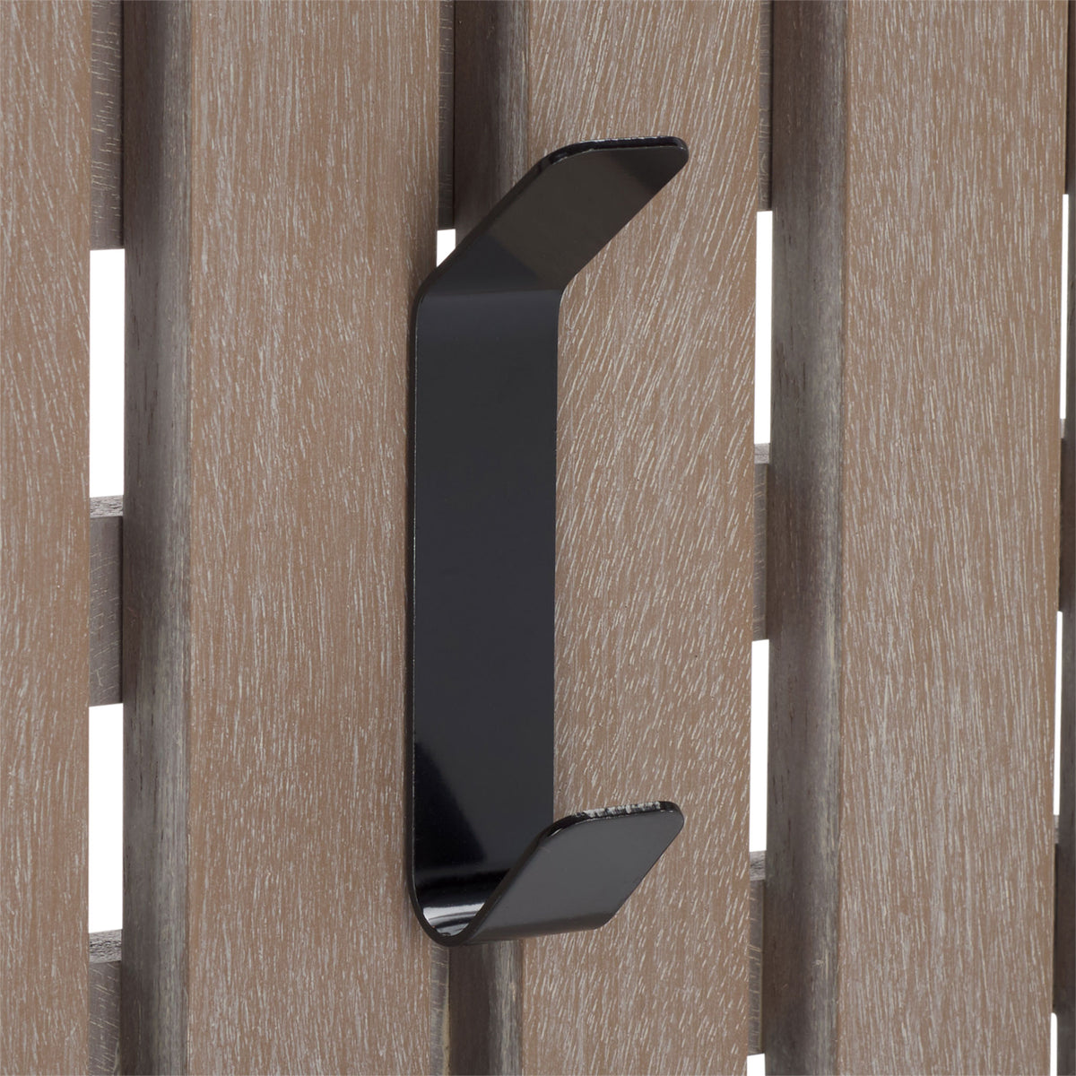 A black double hook highlights the whitewashed grain of wooden slats, keeping daily layers close.