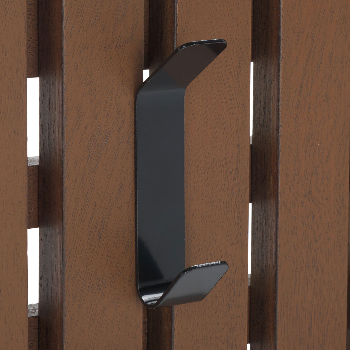 A black dual-prong hook adds everyday utility to warm medium brown wood slats. || STG5704M || detail_studio