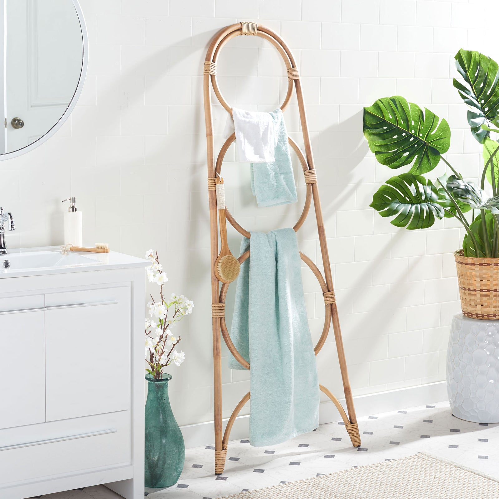 Soft blue towels hang from the honey-brown rattan stand's circular rails. || STG6501C || side_room