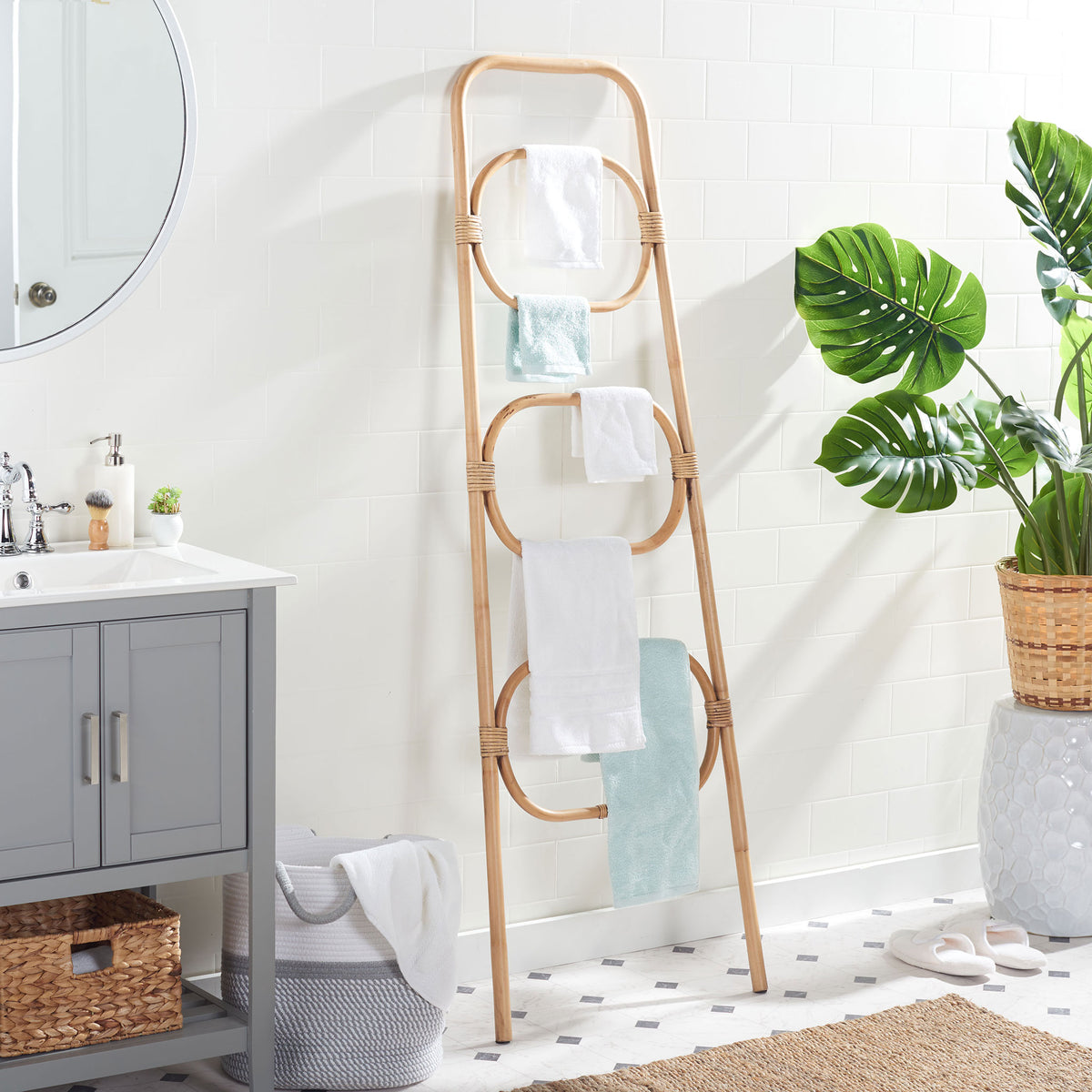 Three honey brown rattan tiers keep soft bath towels neatly arranged by the vanity